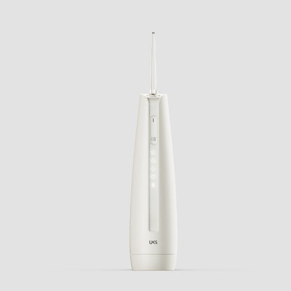 White dental water flosser on a light gray background