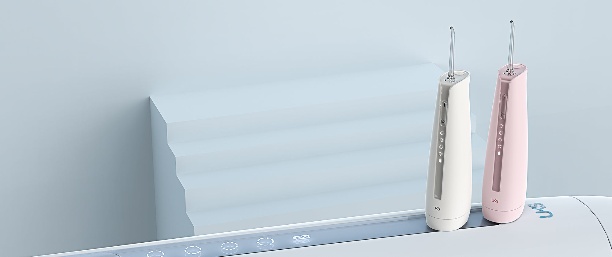 Two electric toothbrushes, one white and one pink, on a light blue surface with a gradient background.
