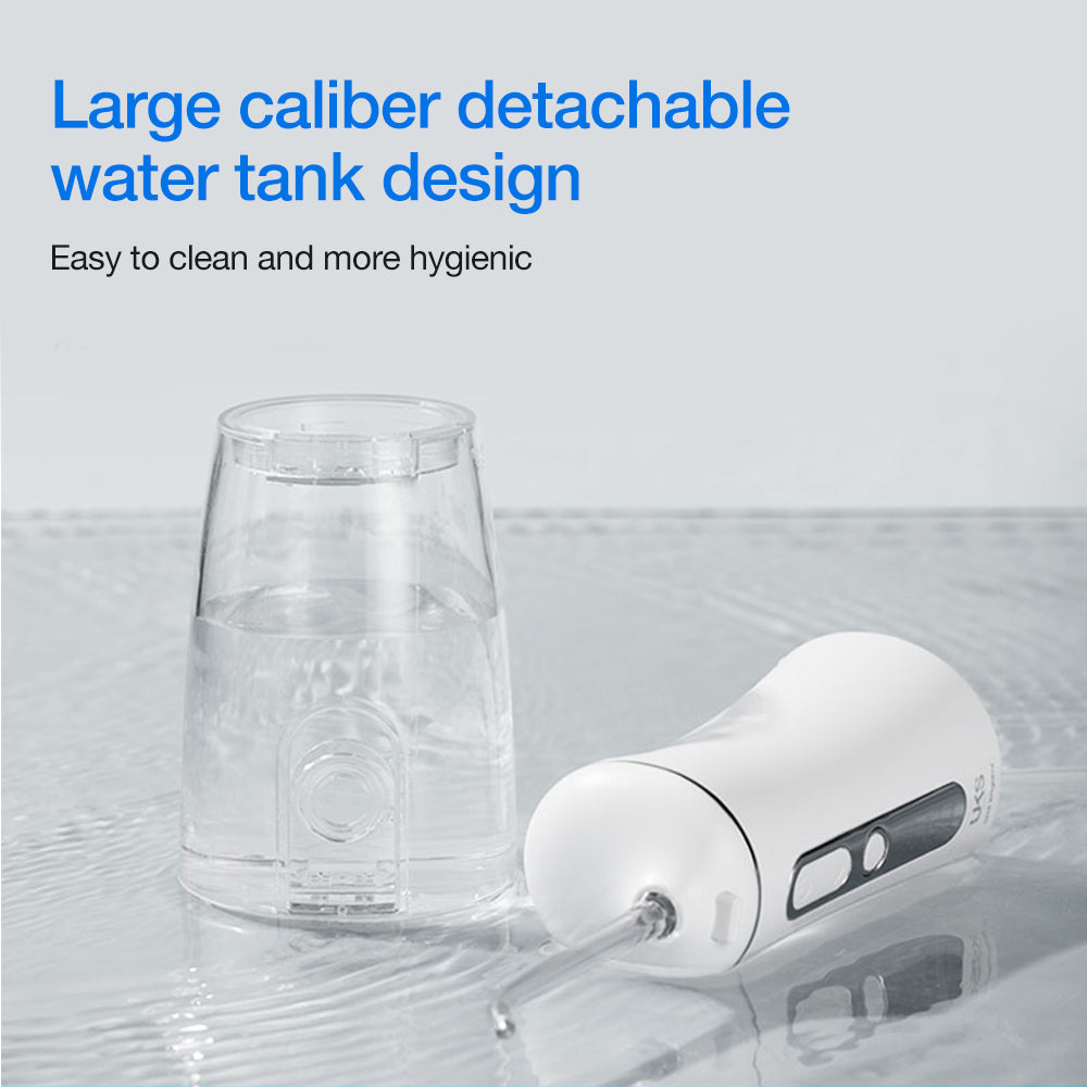 Clear detachable water tank and white device on a light gray background with text about hygiene.